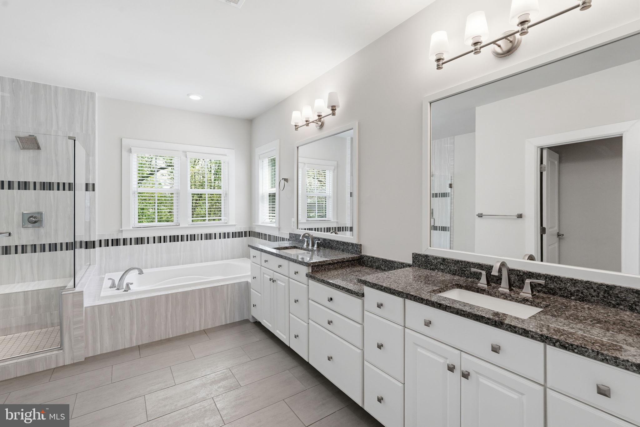 23648 Amesfield Place Aldie, VA 20105 - Photo 30 of 41 a spacious bathroom with a granite countertop double vanity sink a mirror and a bathtub