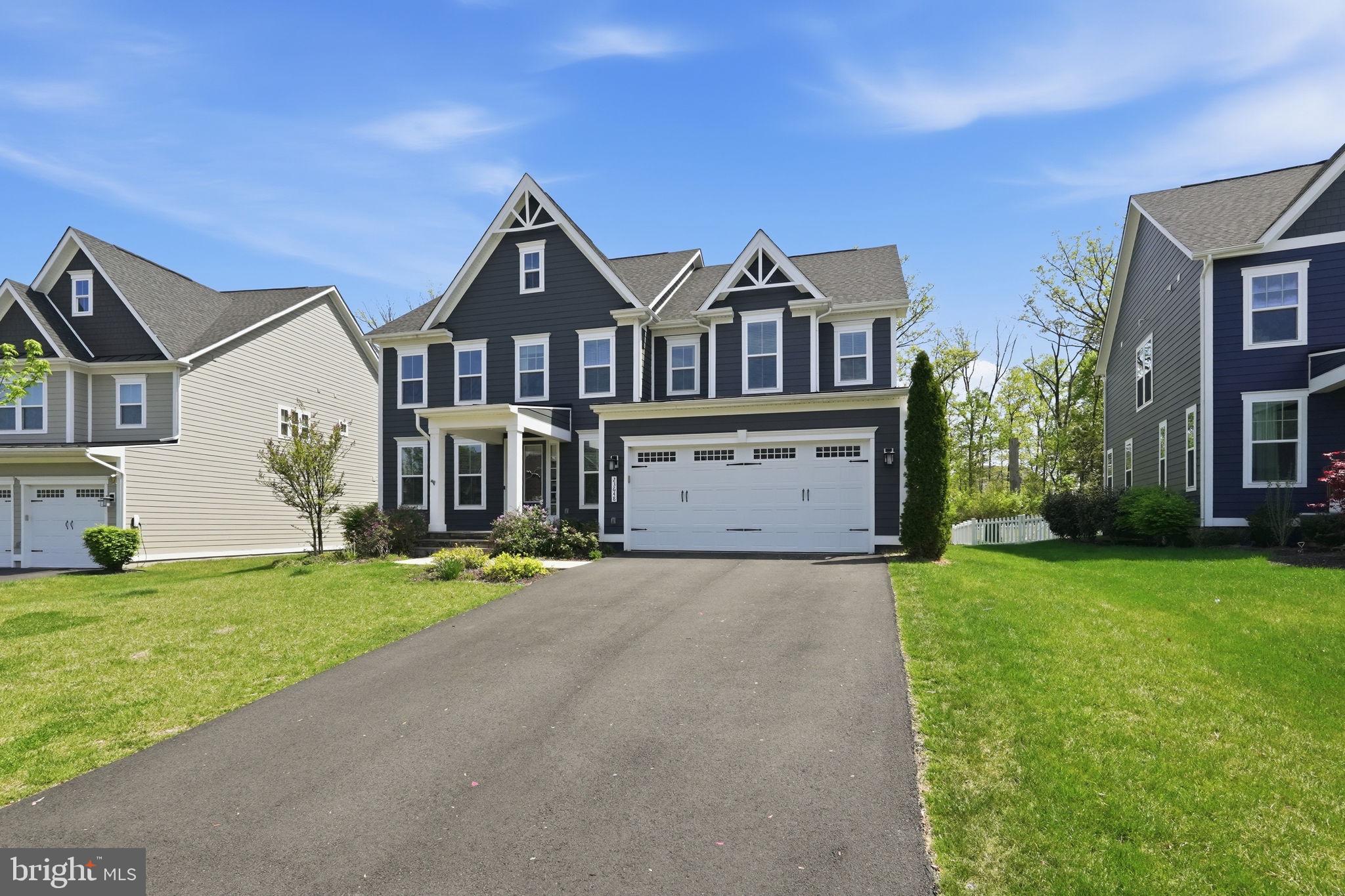 23648 Amesfield Place Aldie, VA 20105 - Photo 3 of 41 a front view of a house with a yard and garage