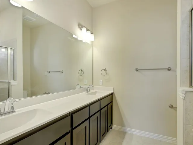 a bathroom with a double vanity sink and a mirror