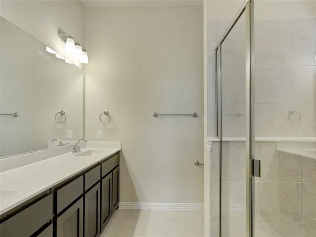 a bathroom with a double vanity sink and a mirror