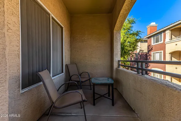 a view of a balcony with chairs