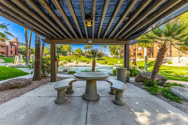 a building outdoor space with patio furniture and potted plants