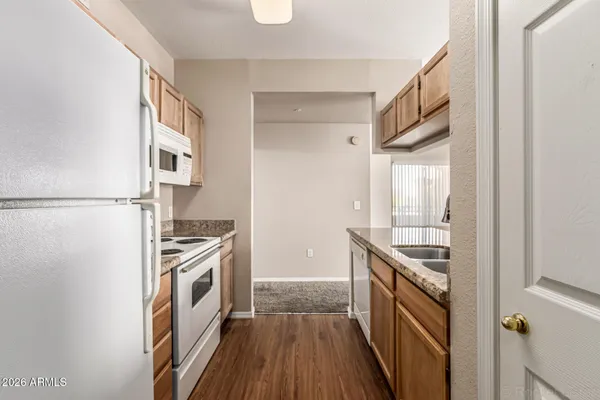 a kitchen with granite countertop a sink and a stove top oven