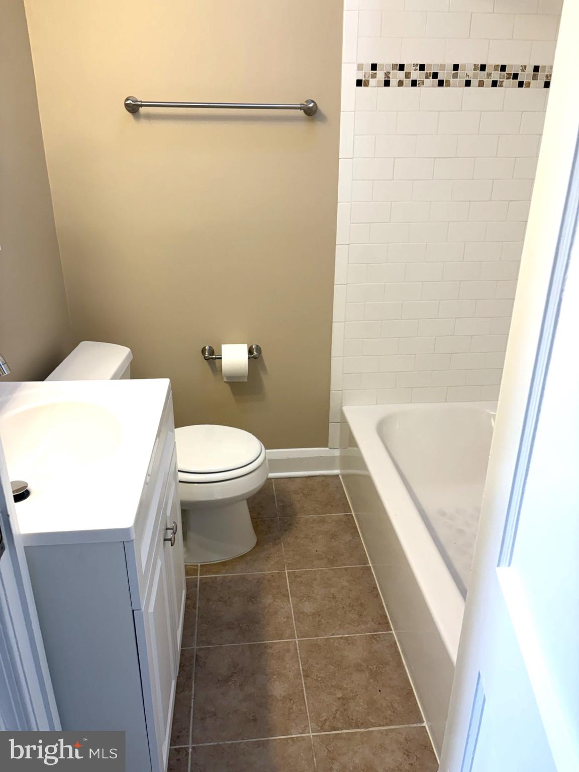 586 Lucia Avenue Baltimore, MD 21229 - Photo 12 of 14 a bathroom with a sink a toilet and shower
