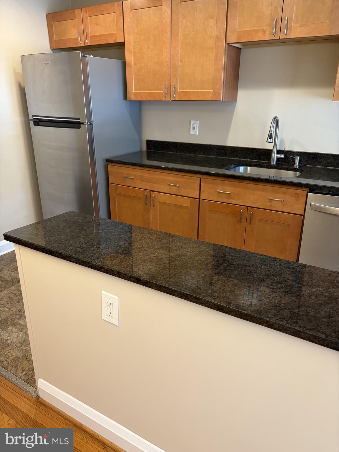 586 Lucia Avenue Baltimore, MD 21229 - Photo 5 of 14 a kitchen with granite countertop cabinets and sink