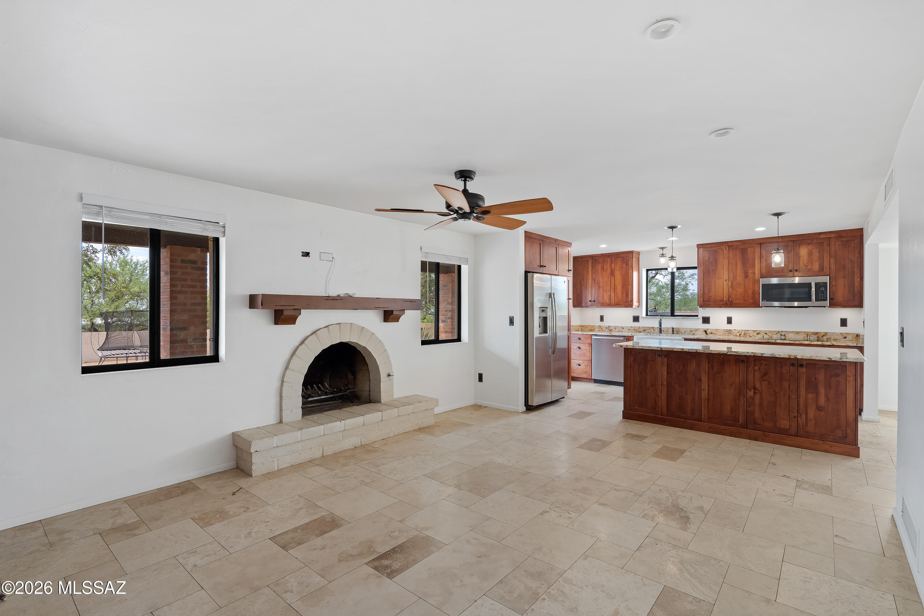 9420 East Ravine Trail Tucson, AZ 85749 - Photo 10 of 39 a view of a kitchen with a fireplace and window