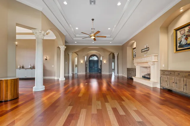 a bedroom with a large bed and a chandelier