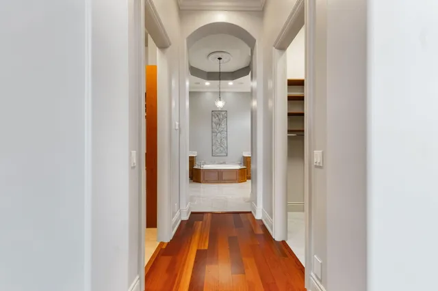 an empty room with a window and a chandelier fan