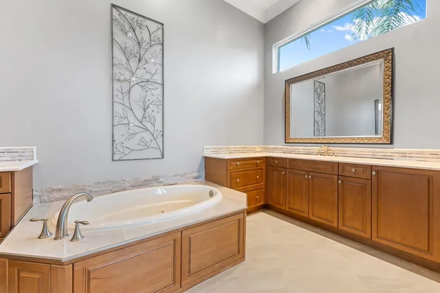 a view of a house with swimming pool and sitting area