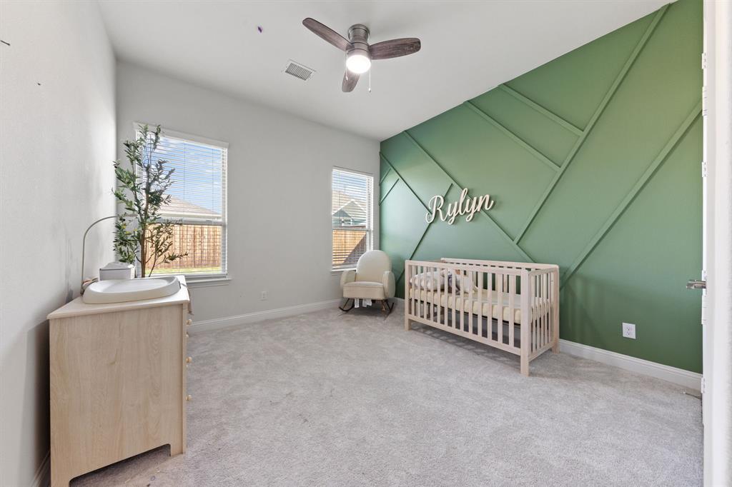 8808 Royal Star Road Rowlett, TX 75089 - Photo 27 of 40 a view of an empty room with a window and a ceiling fan