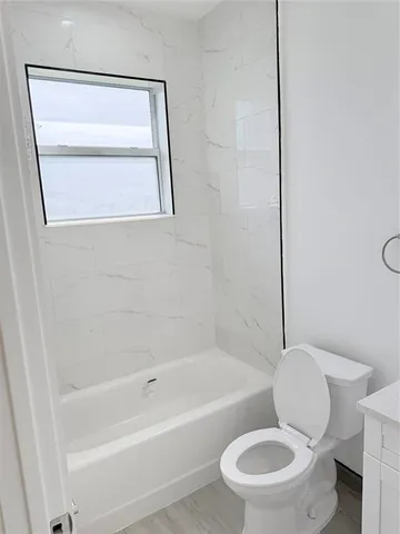 a bathroom with a toilet and a bathtub