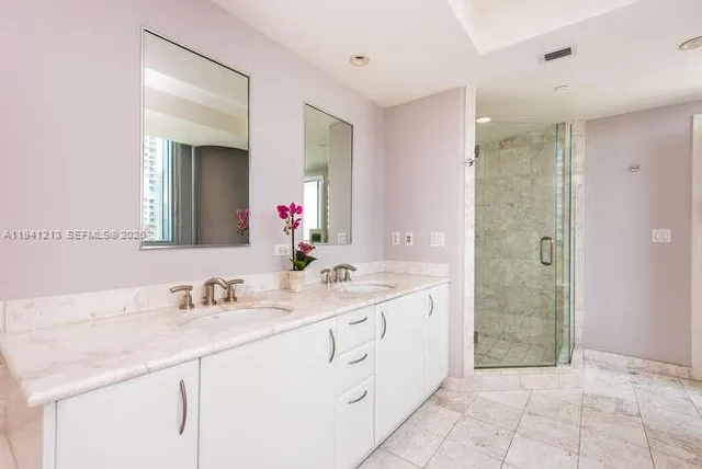 a bathroom with a granite countertop sink mirror and a