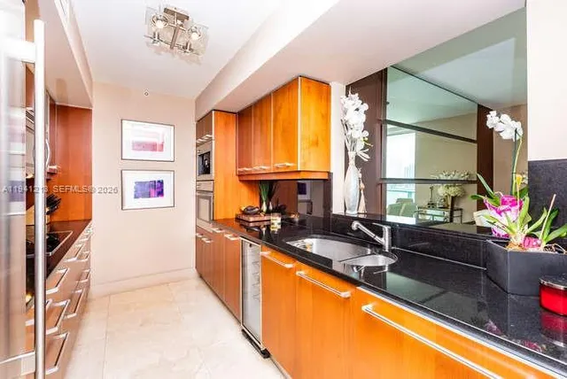 a kitchen with a sink stove and refrigerator