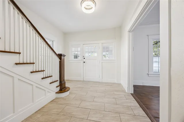 a view of entryway with wooden floor and stairs