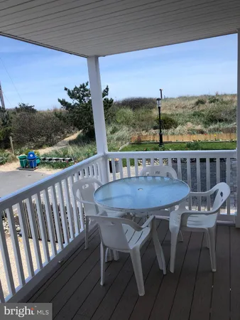 a view of a chairs and table on the balcony