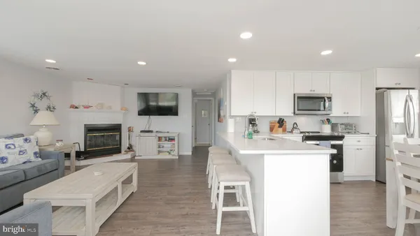 a kitchen with white cabinets stainless steel appliances and sink