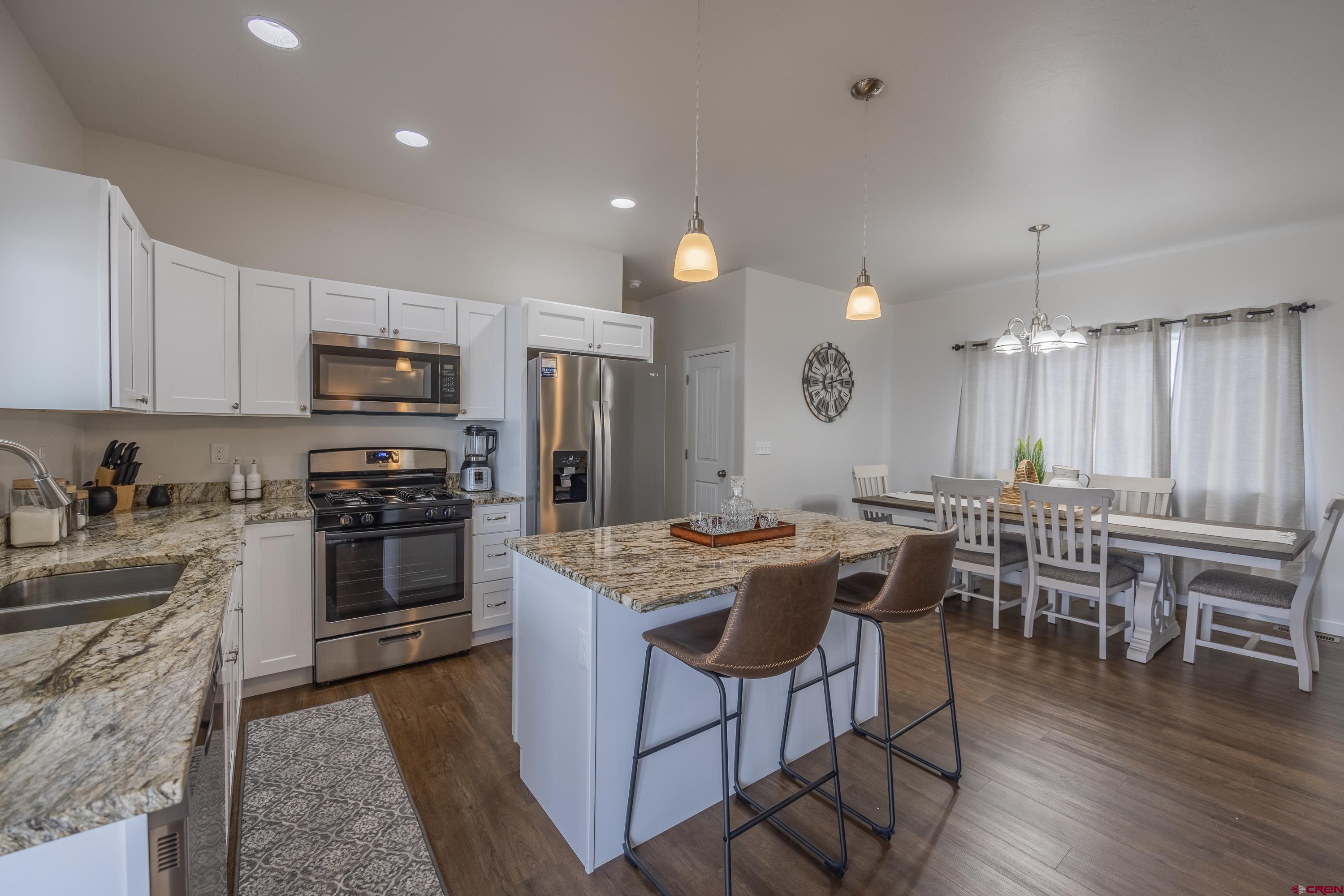 1725 Moonlight Drive Montrose, CO 81401 - Photo 14 of 35 a kitchen with lots of counter top space and stainless steel appliances