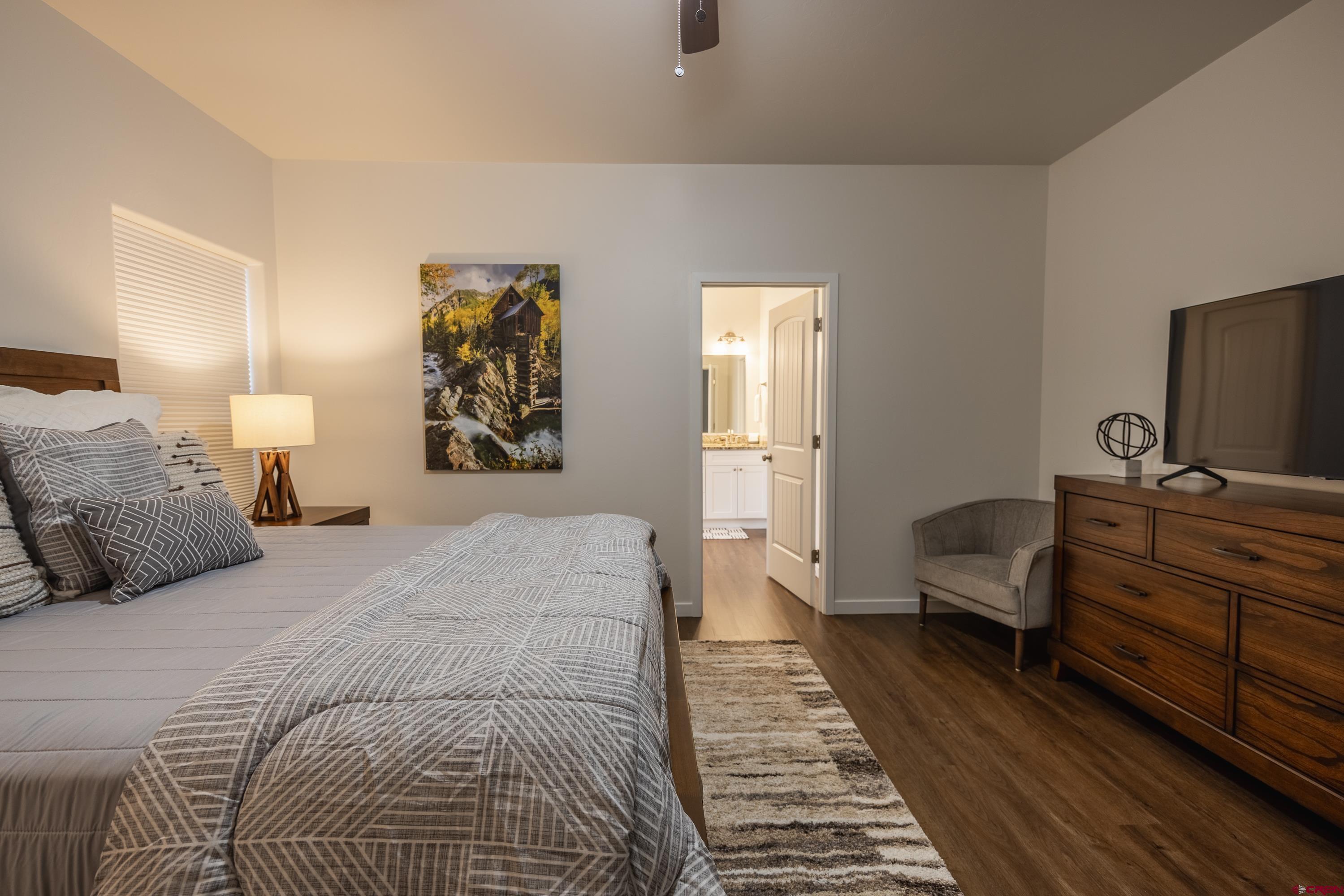 1725 Moonlight Drive Montrose, CO 81401 - Photo 19 of 35 a bedroom with a large bed and a couch