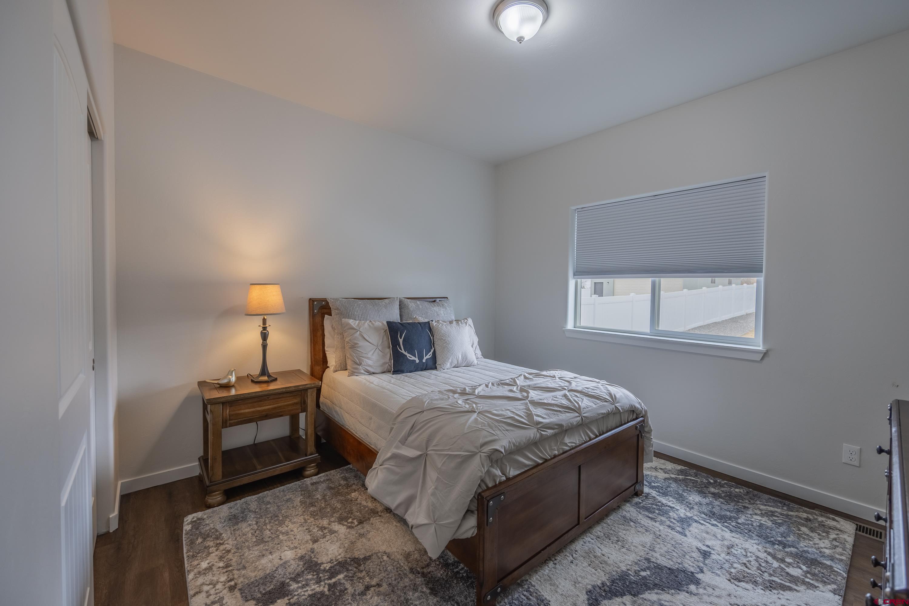 1725 Moonlight Drive Montrose, CO 81401 - Photo 25 of 35 a bedroom with a bed and a window