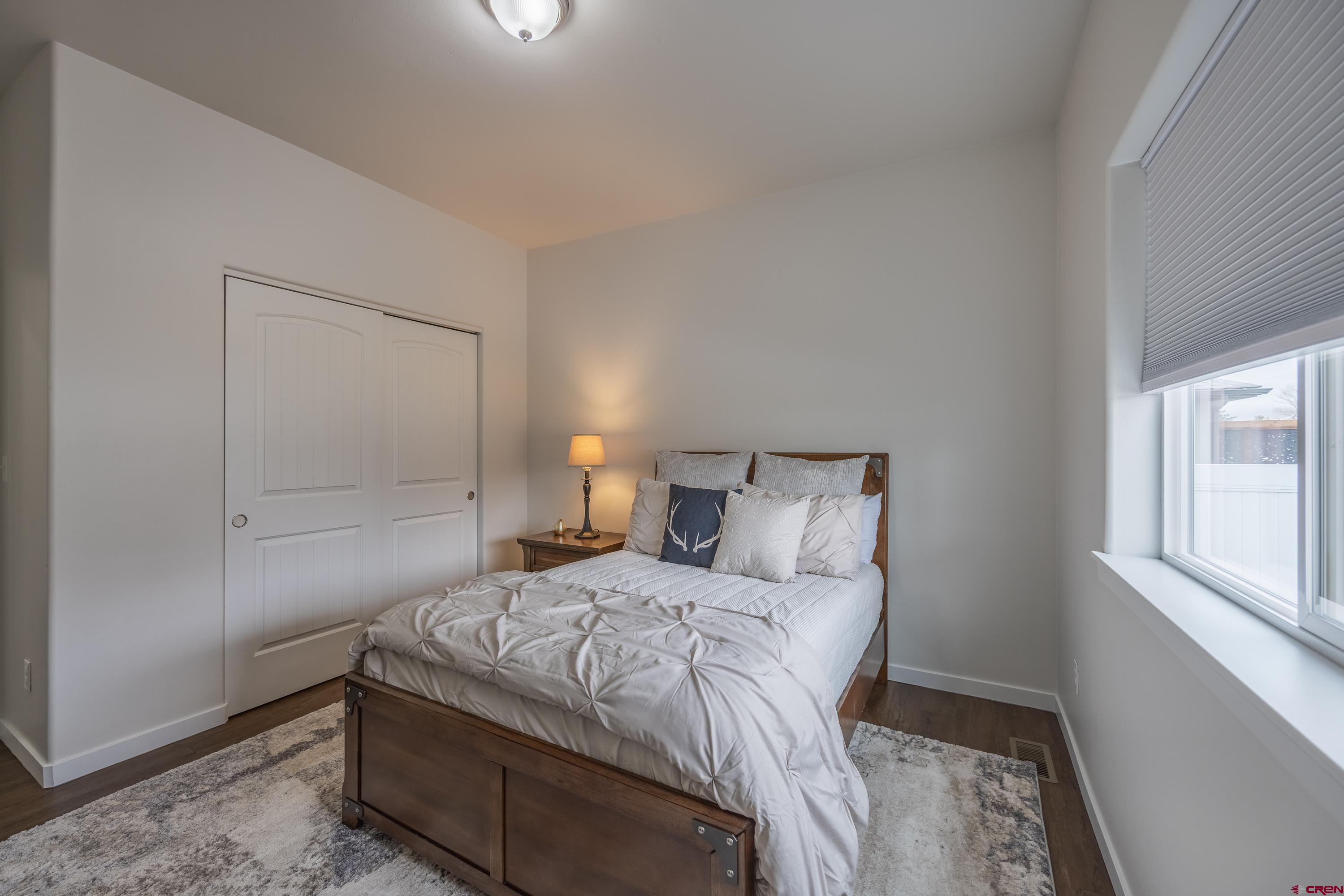 1725 Moonlight Drive Montrose, CO 81401 - Photo 26 of 35 a bedroom with a bed and a window