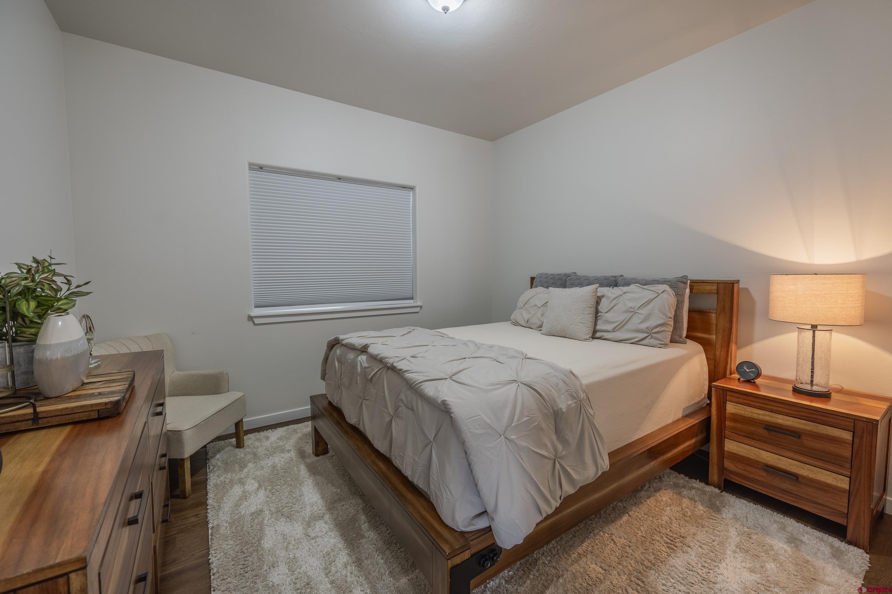 1725 Moonlight Drive Montrose, CO 81401 - Photo 29 of 35 a bedroom with a bed and a potted plant