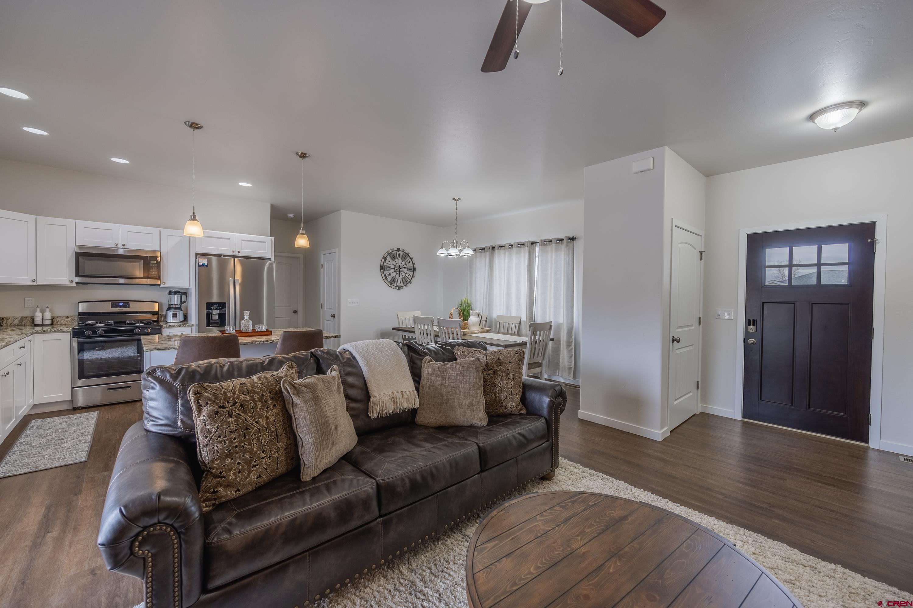 1725 Moonlight Drive Montrose, CO 81401 - Photo 5 of 35 a view of living room kitchen with furniture and wooden floor