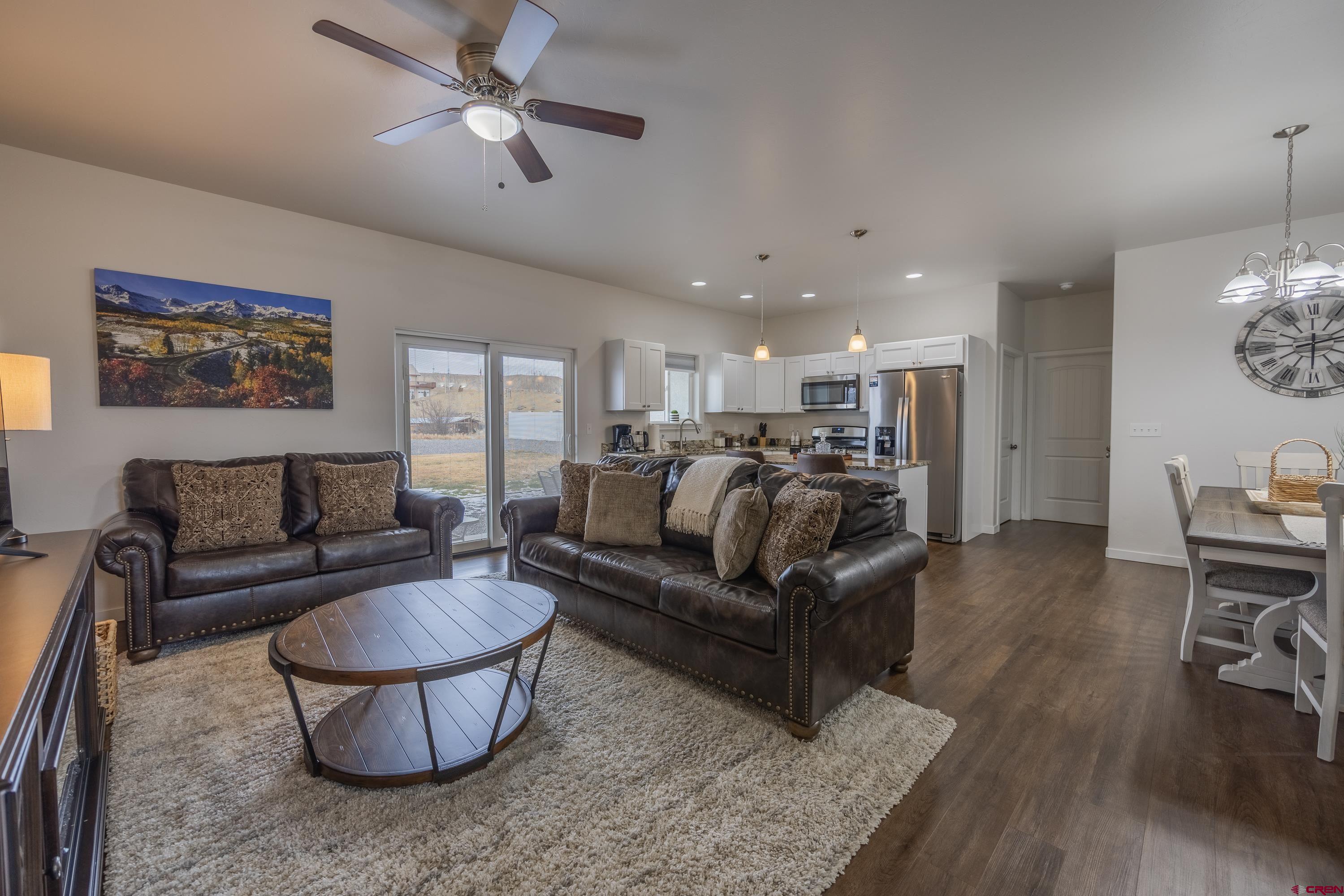 1725 Moonlight Drive Montrose, CO 81401 - Photo 7 of 35 a living room with furniture and a chandelier