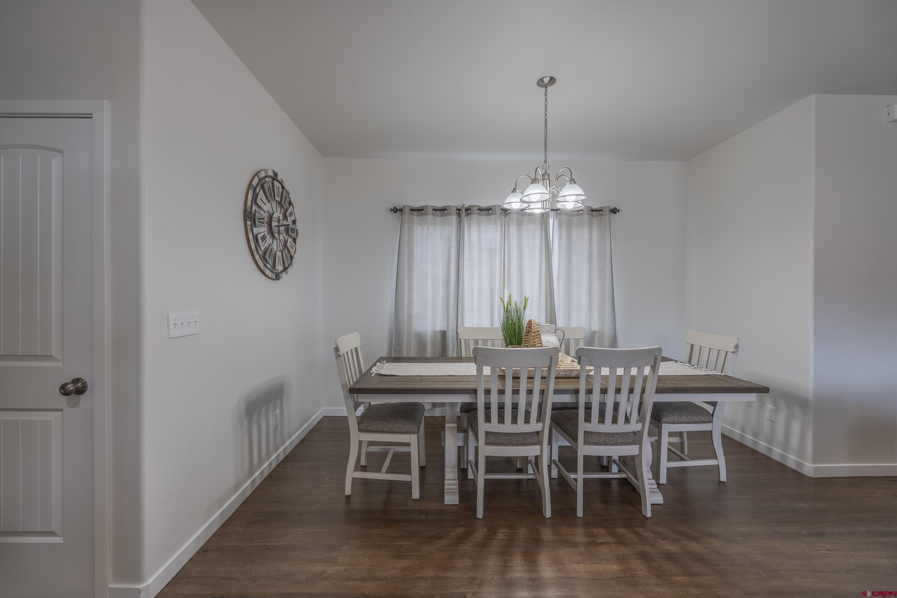 1725 Moonlight Drive Montrose, CO 81401 - Photo 9 of 35 a view of a dining room with furniture window and wooden floor