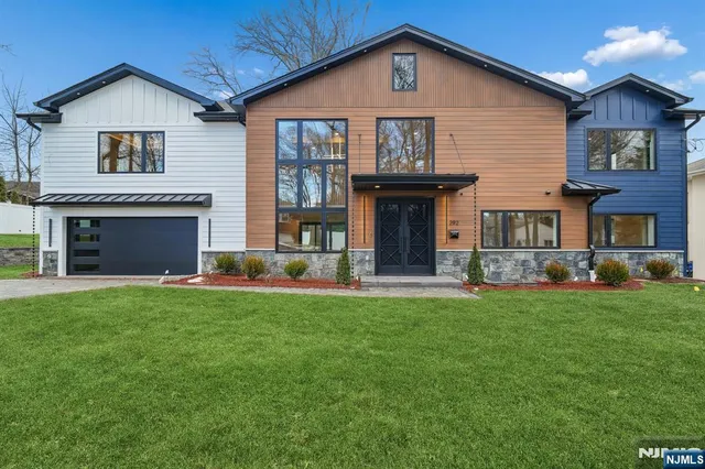 a front view of a house with a yard and garage