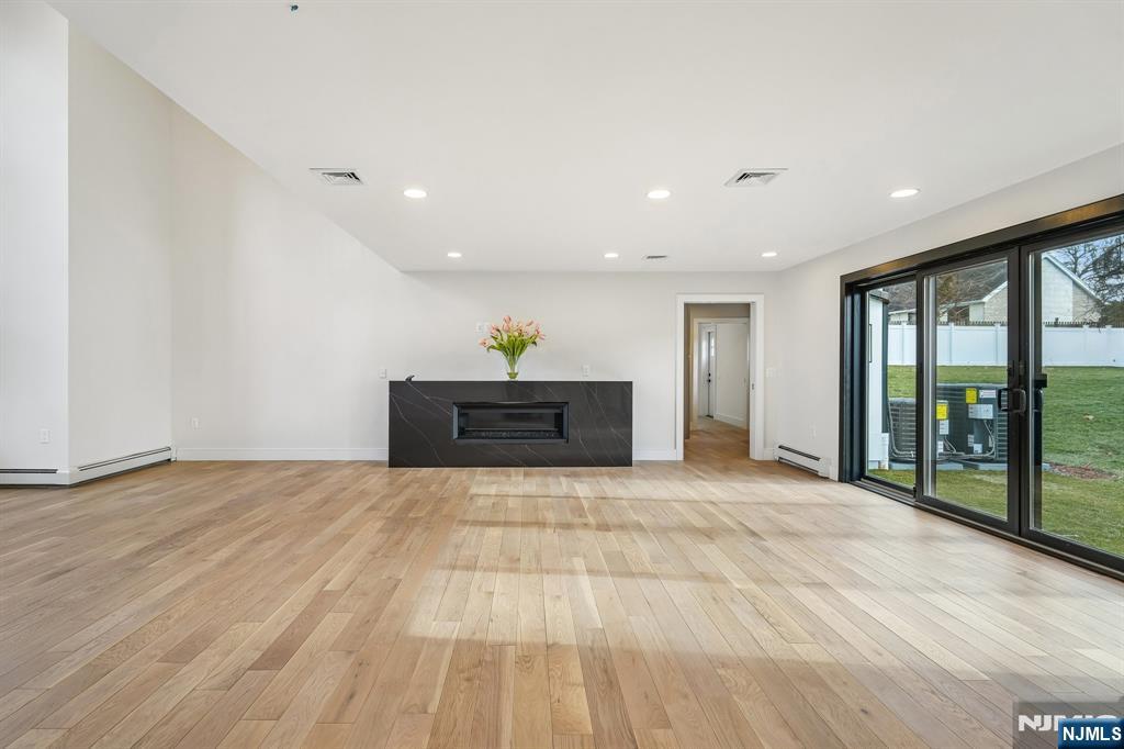 292 Magnolia Avenue Cresskill, NJ 07626 - Photo 11 of 50 a view of an empty room with a fireplace and a window