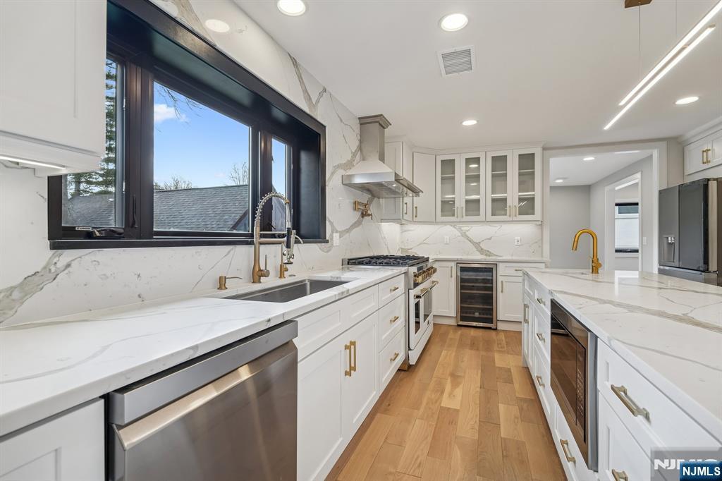 292 Magnolia Avenue Cresskill, NJ 07626 - Photo 13 of 50 a large kitchen with a sink and cabinets