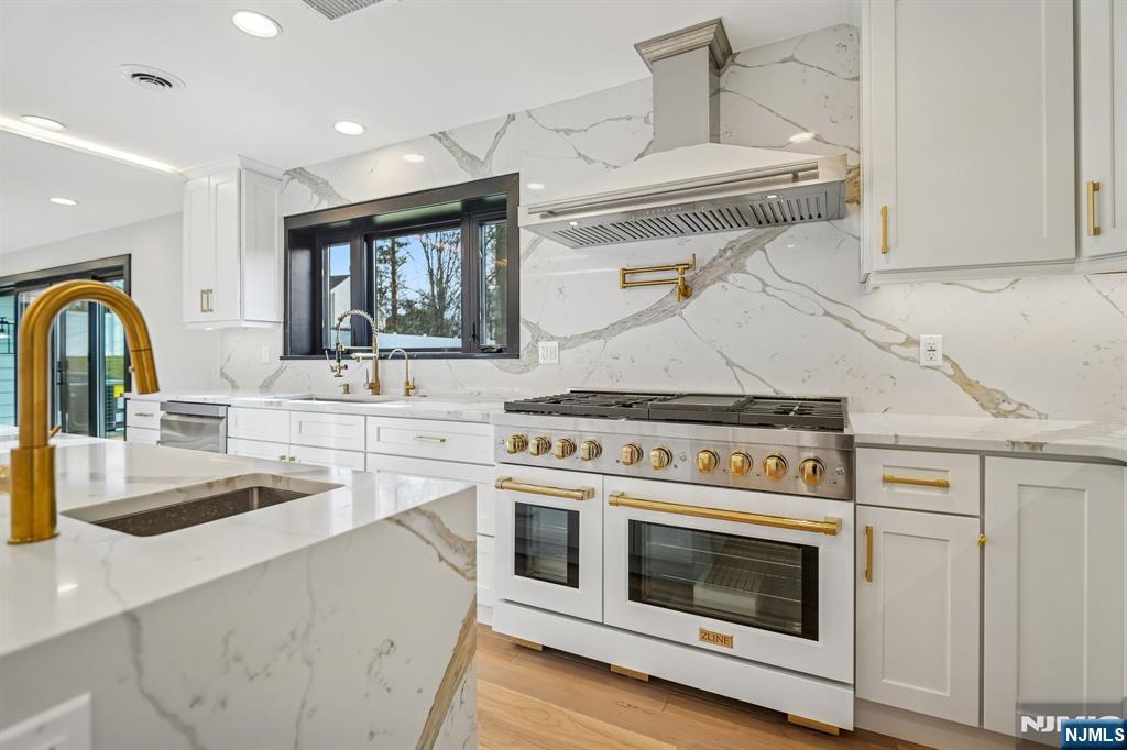292 Magnolia Avenue Cresskill, NJ 07626 - Photo 14 of 50 a kitchen with stainless steel appliances granite countertop a stove and a sink
