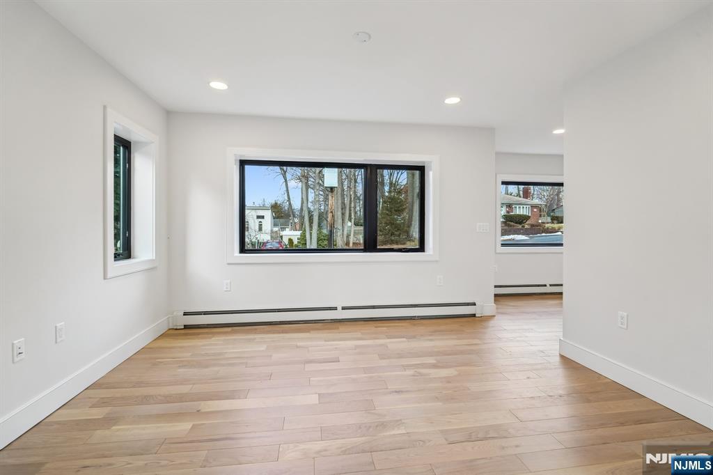 292 Magnolia Avenue Cresskill, NJ 07626 - Photo 19 of 50 a view of an empty room with a window and wooden floor