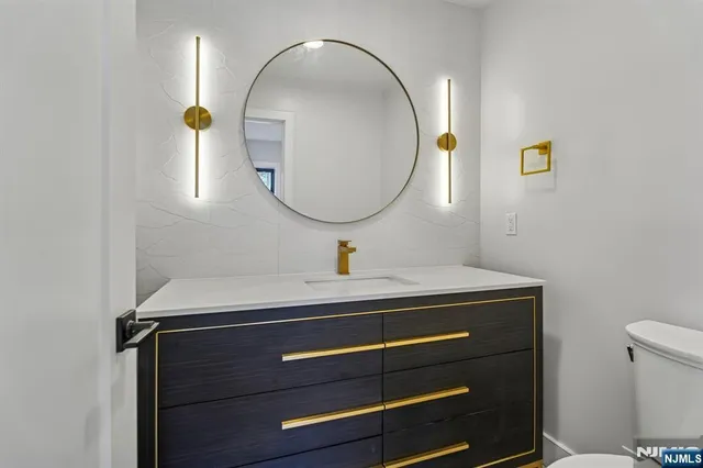a bathroom with a sink mirror and vanity
