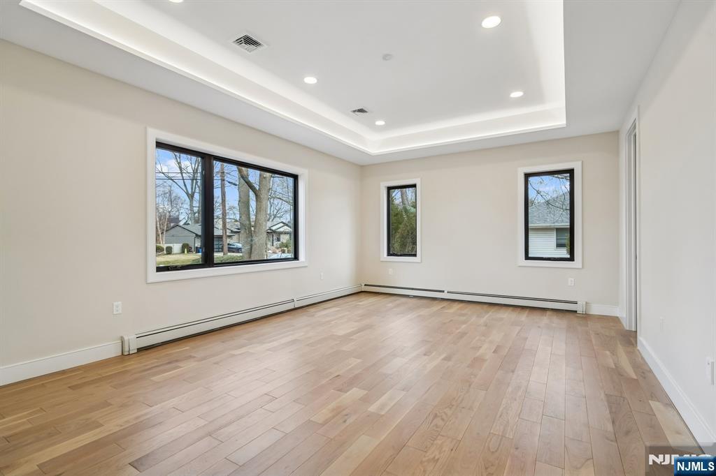 292 Magnolia Avenue Cresskill, NJ 07626 - Photo 27 of 50 an empty room with wooden floor and windows
