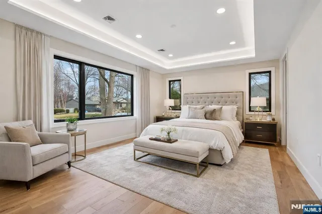 a bedroom with a bed and a large window