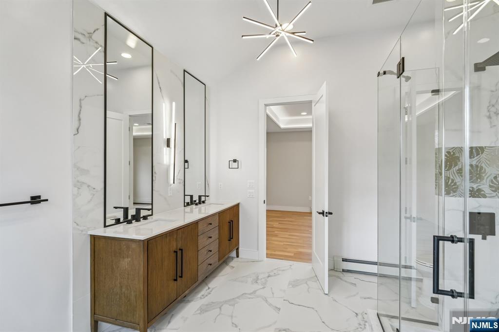 292 Magnolia Avenue Cresskill, NJ 07626 - Photo 31 of 50 a bathroom with a double vanity sink a mirror and a shower