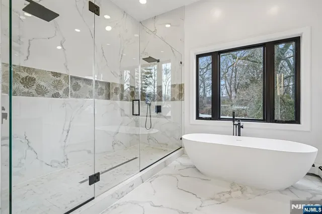 a bathroom with a bathtub and large window