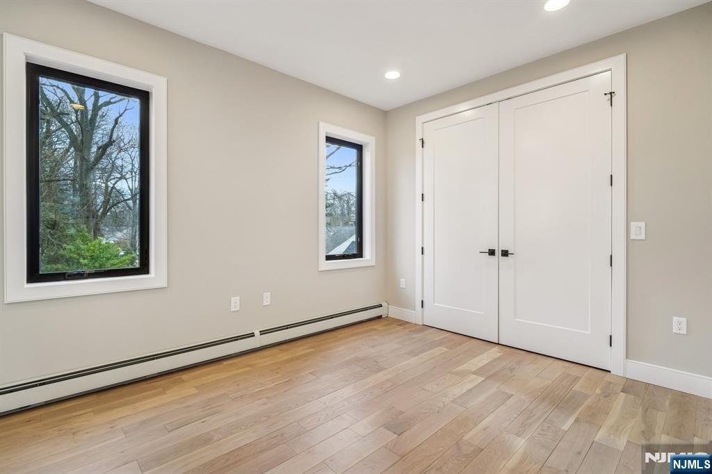 292 Magnolia Avenue Cresskill, NJ 07626 - Photo 33 of 50 a view of an empty room with wooden floor and a window