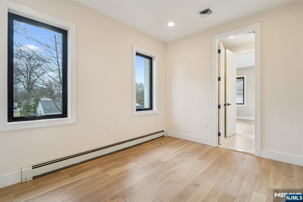 292 Magnolia Avenue Cresskill, NJ 07626 - Photo 36 of 50 an empty room with wooden floor and a window