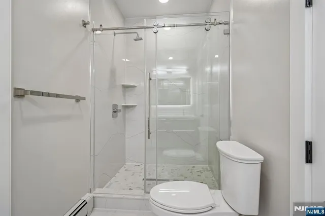 a bathroom with a toilet and a shower