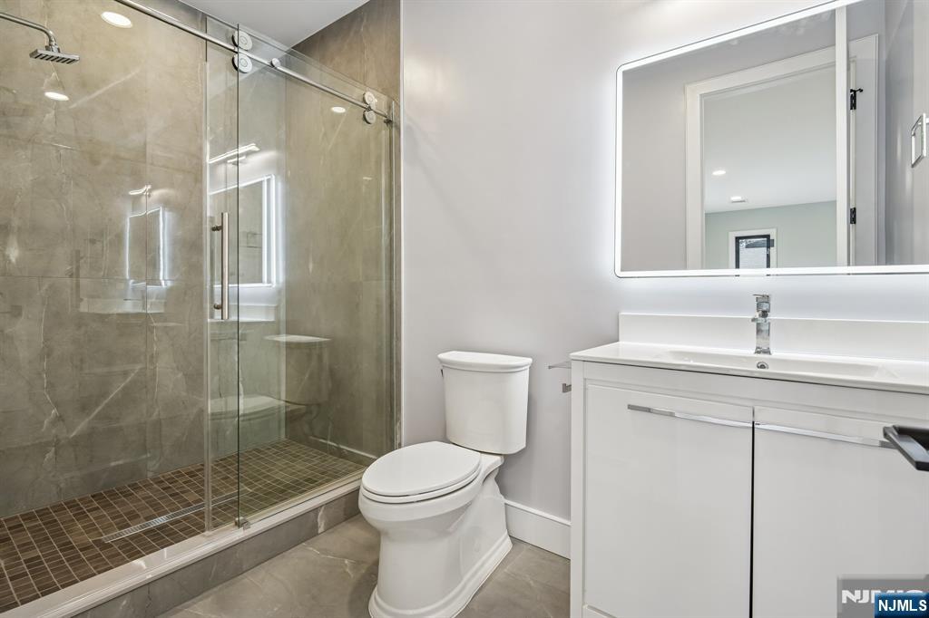 292 Magnolia Avenue Cresskill, NJ 07626 - Photo 42 of 50 a bathroom with a shower sink mirror and toilet