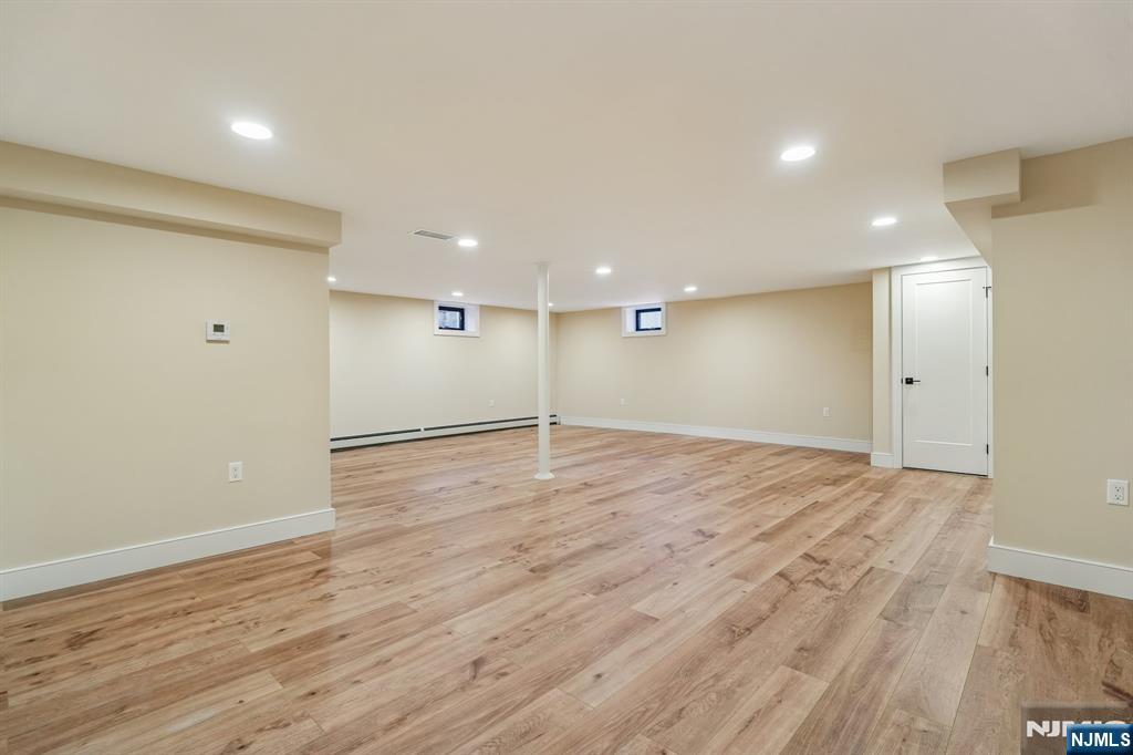292 Magnolia Avenue Cresskill, NJ 07626 - Photo 43 of 50 an empty room with wooden floor and windows