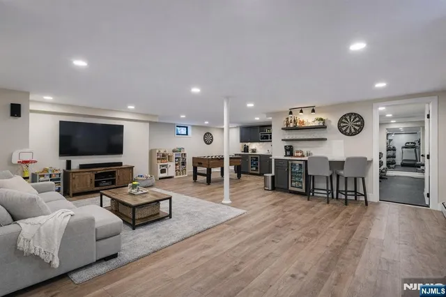 a living room with furniture kitchen view and a flat screen tv