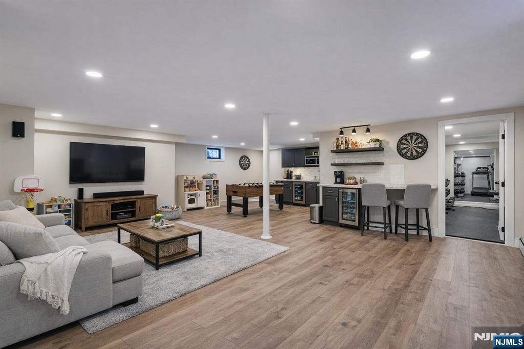292 Magnolia Avenue Cresskill, NJ 07626 - Photo 44 of 50 a living room with furniture kitchen view and a flat screen tv