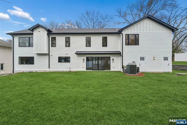 a view of an house with backyard space and garden