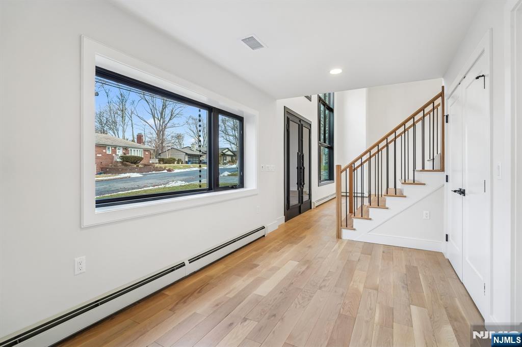 292 Magnolia Avenue Cresskill, NJ 07626 - Photo 8 of 50 a view of a hallway with wooden floor and stairs