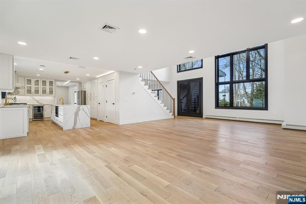 292 Magnolia Avenue Cresskill, NJ 07626 - Photo 9 of 50 a view of an empty room with a kitchen and a window