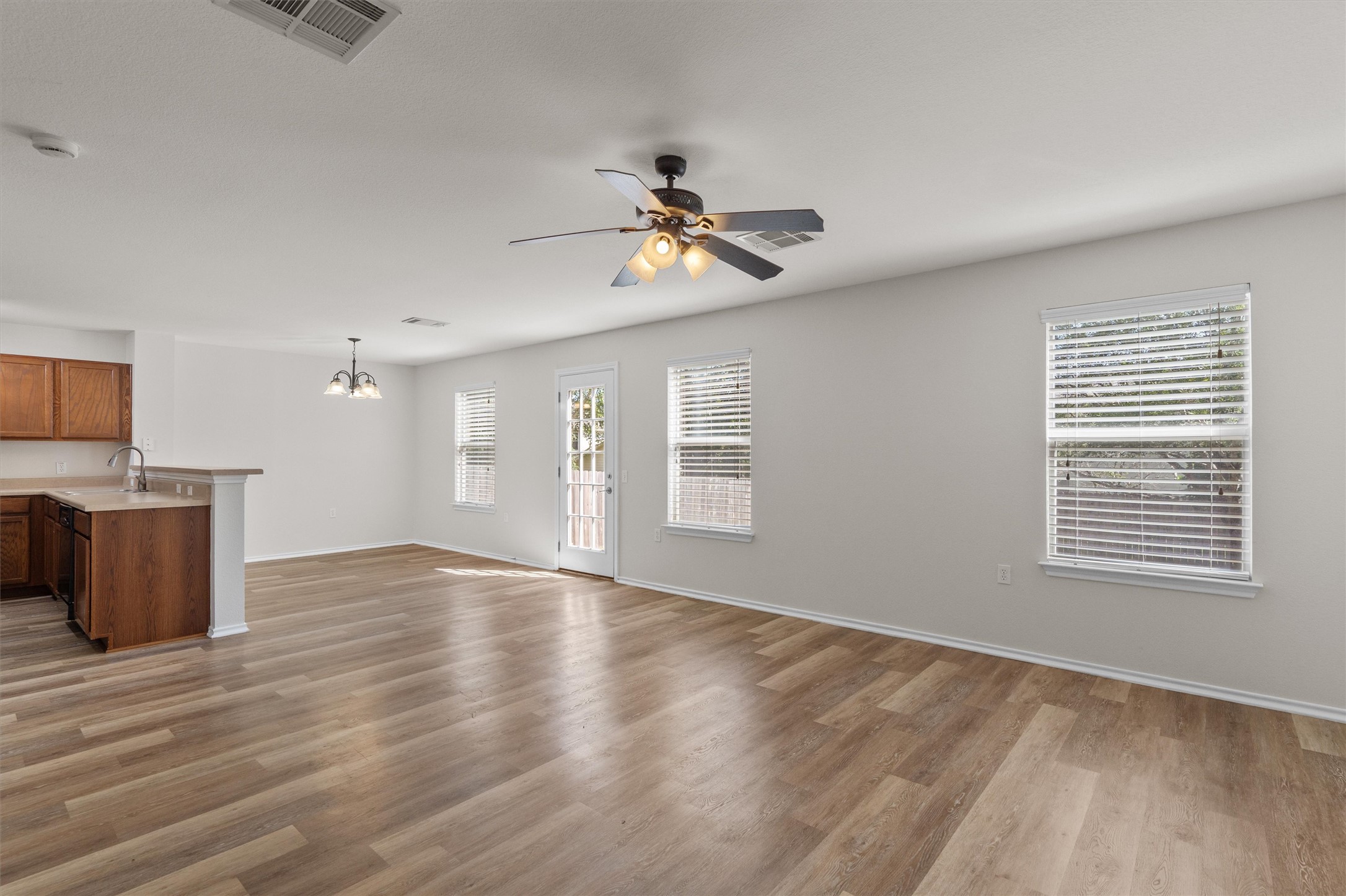5825 Silver Screen Drive Austin, TX 78747 - Photo 8 of 40 An open-concept living space with resilient flooring and natural light, perfect for everyday living.
