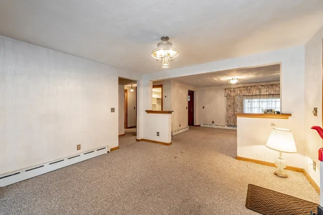 a view of a livingroom with a furniture and cabinet with hallway